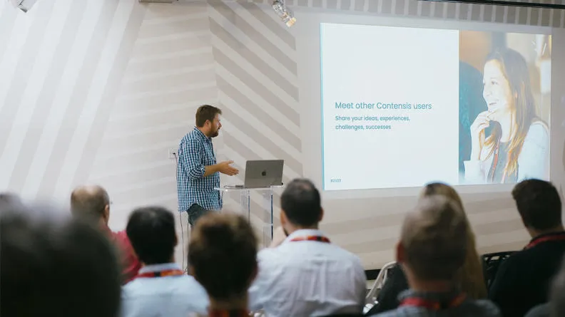 A man stood presenting to a crowd